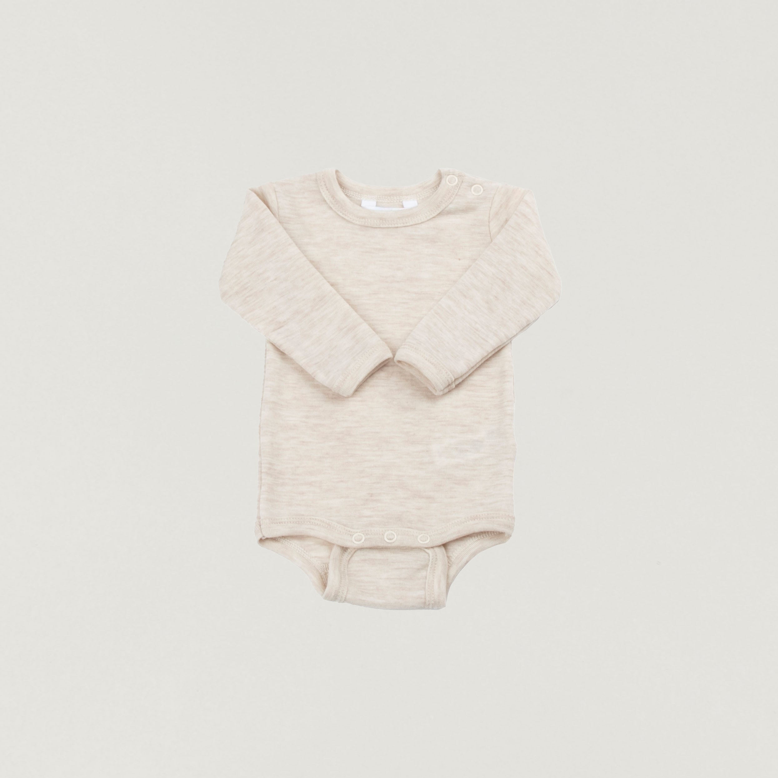 Long-sleeved wool bodysuit in cream melange by Joha